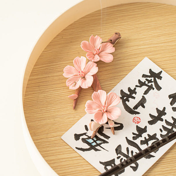 Plum Blossom Incense Burner – Pink ceramic sakura on bamboo tray with calligraphy card, zen meditation