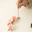 Plum Blossom Incense Burner – Hand placing stick into pink ceramic sakura flowers, incense holder