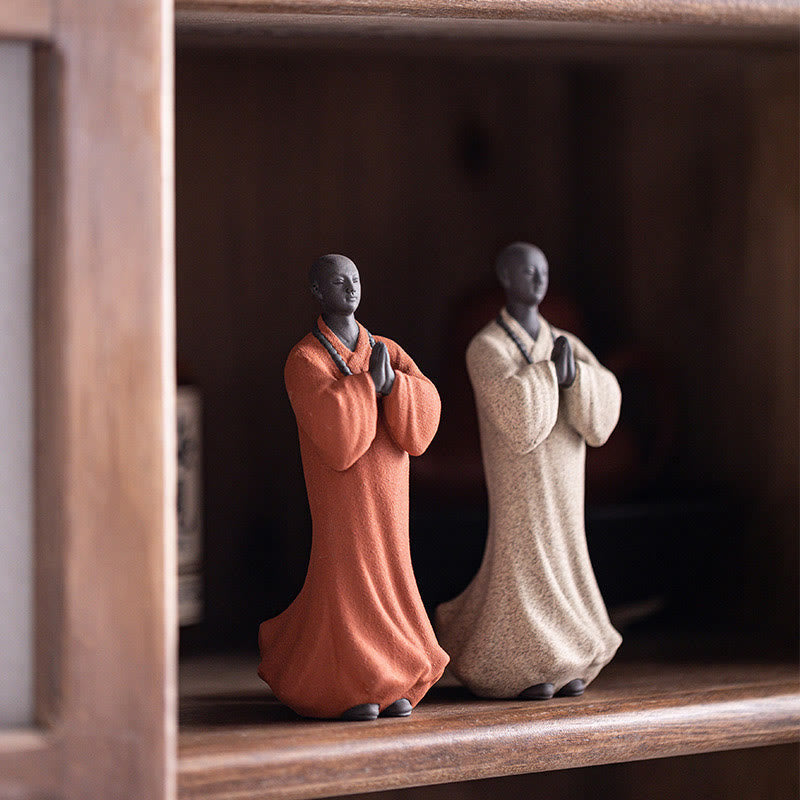 Ceramic Meditating Monk Figure – warm lighting on face highlighting serene smile