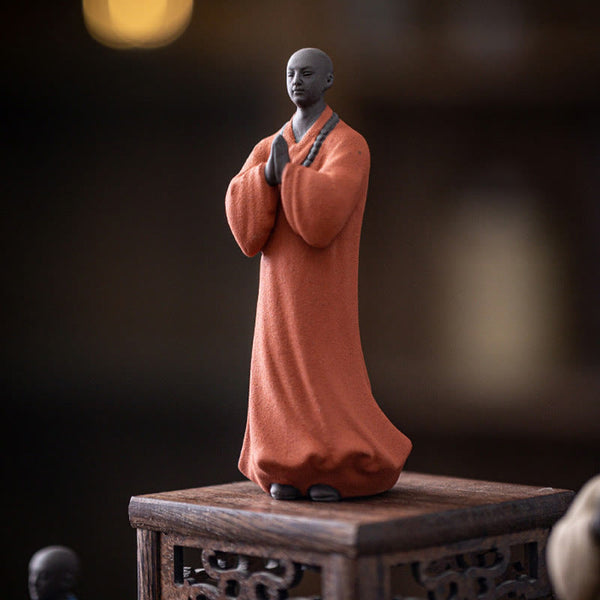 Ceramic Meditating Monk Figure – size comparison with tea cup, compact desk ornament