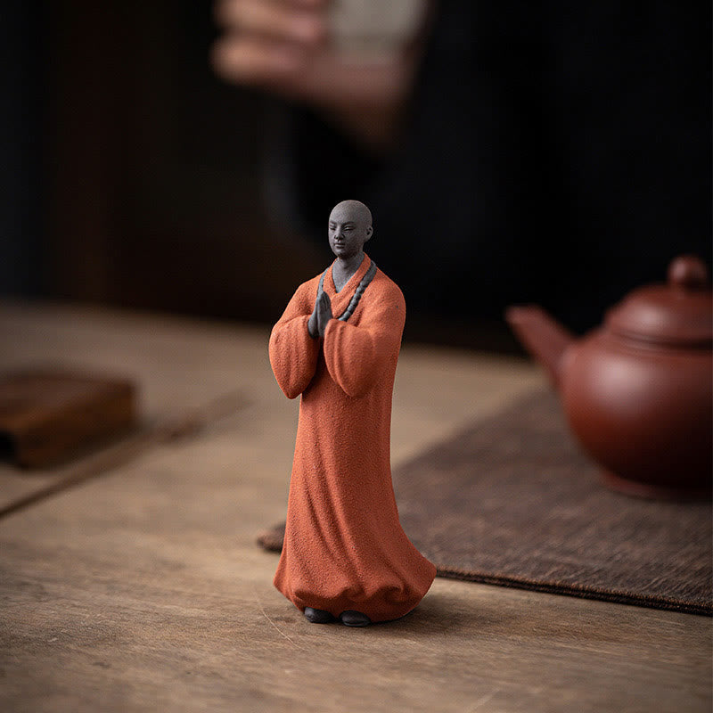 Ceramic Meditating Monk Figure – next to succulent plant, modern shelf arrangement