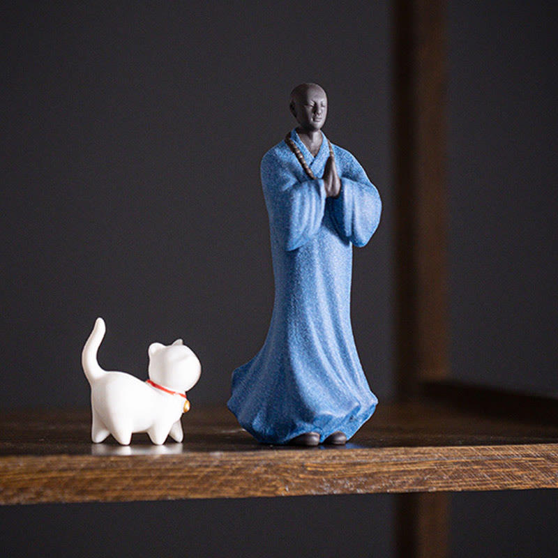 Ceramic Meditating Monk Figure – soft fabric background, gentle product photography
