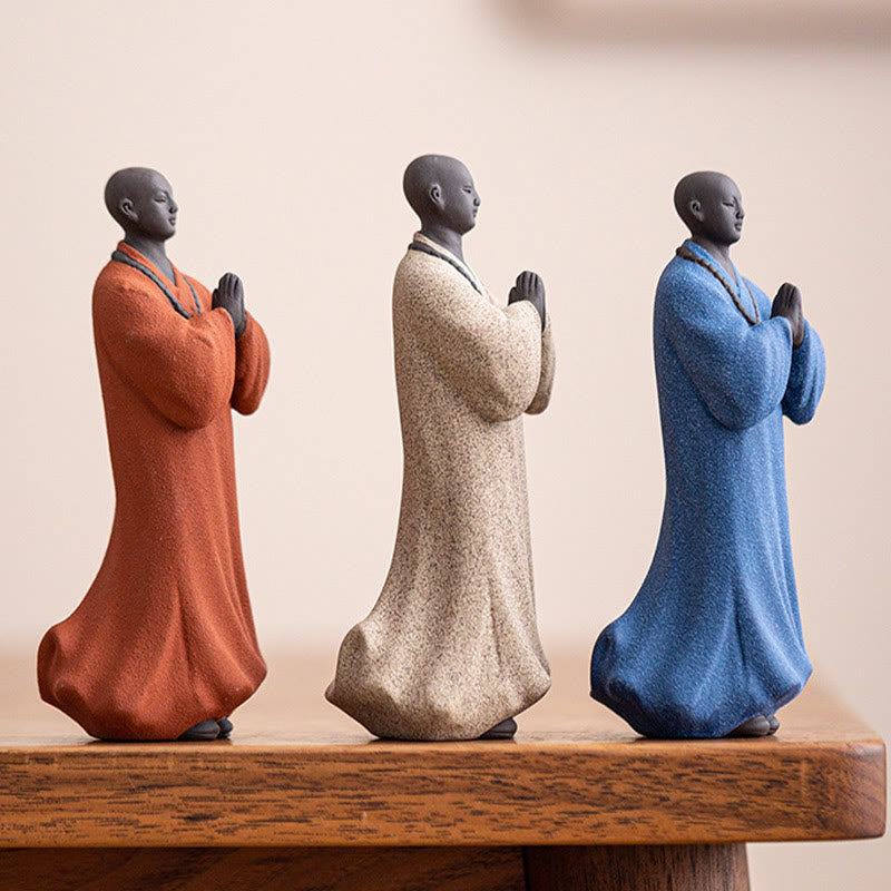 Ceramic Meditating Monk Figure – on wooden shelf with books, minimalist home styling