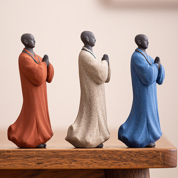 Ceramic Meditating Monk Figure – on wooden shelf with books, minimalist home styling