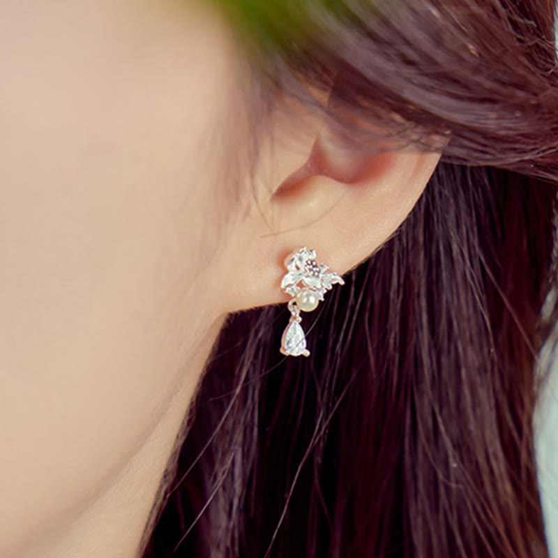 Hetian Jade & Sterling Silver Lotus Moon Earrings - silver lotus stud earring on ear, soft green bokeh background