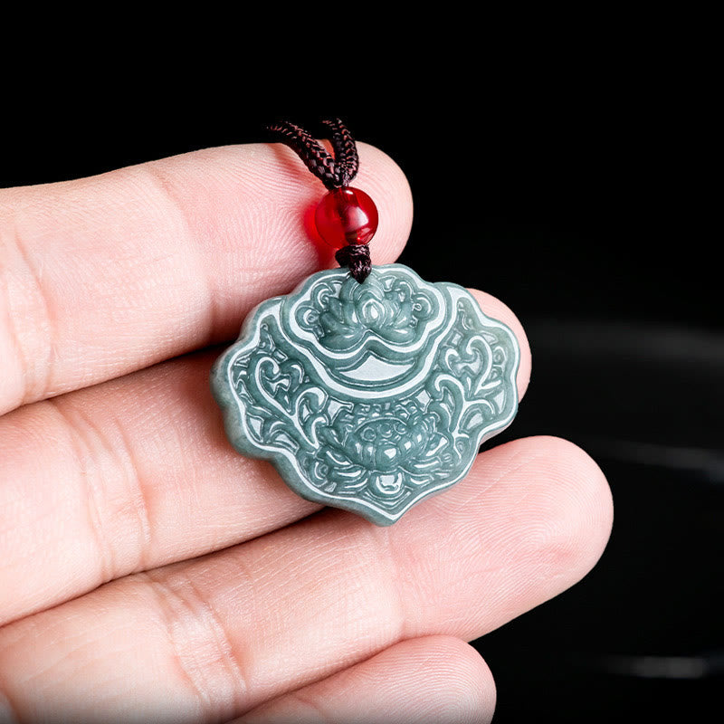 Lotus Pattern Carved Jade Pendant Necklace - jade lotus pendant held between fingers showing scale, black background