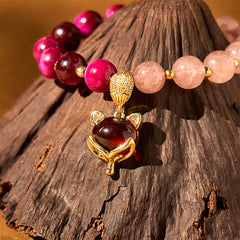 Natural Strawberry Quartz Love Bracelet – fox charm close-up dark wood gold setting red gemstone