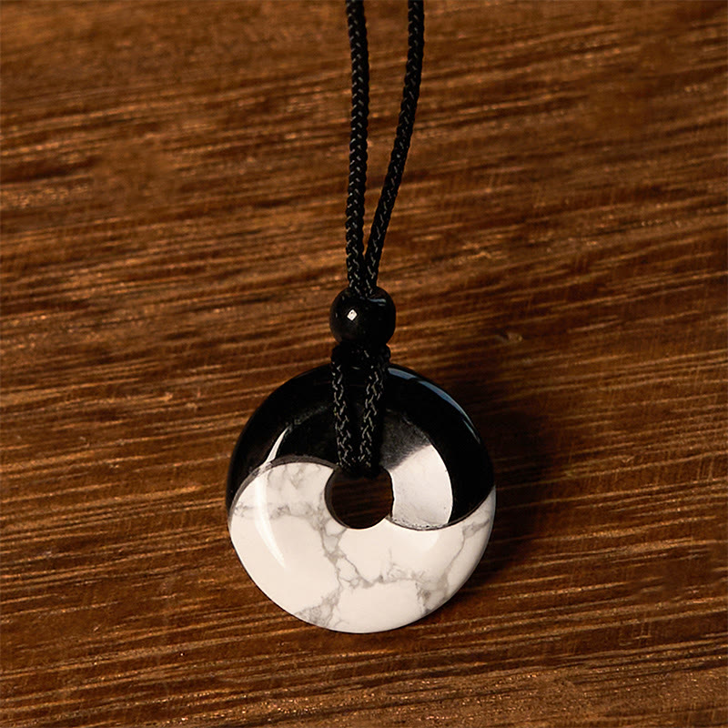 Obsidian White Turquoise Yin Yang Peace Buckle Necklace - Front view of circular yin-yang pendant with glossy black stone ...