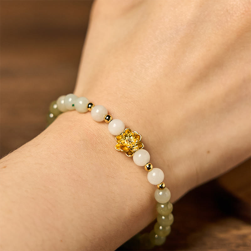 Natural Hetian Jade Gradient Lotus Bracelet – wrist close-up, white-to-green jade beads with gold lotus, tranquil