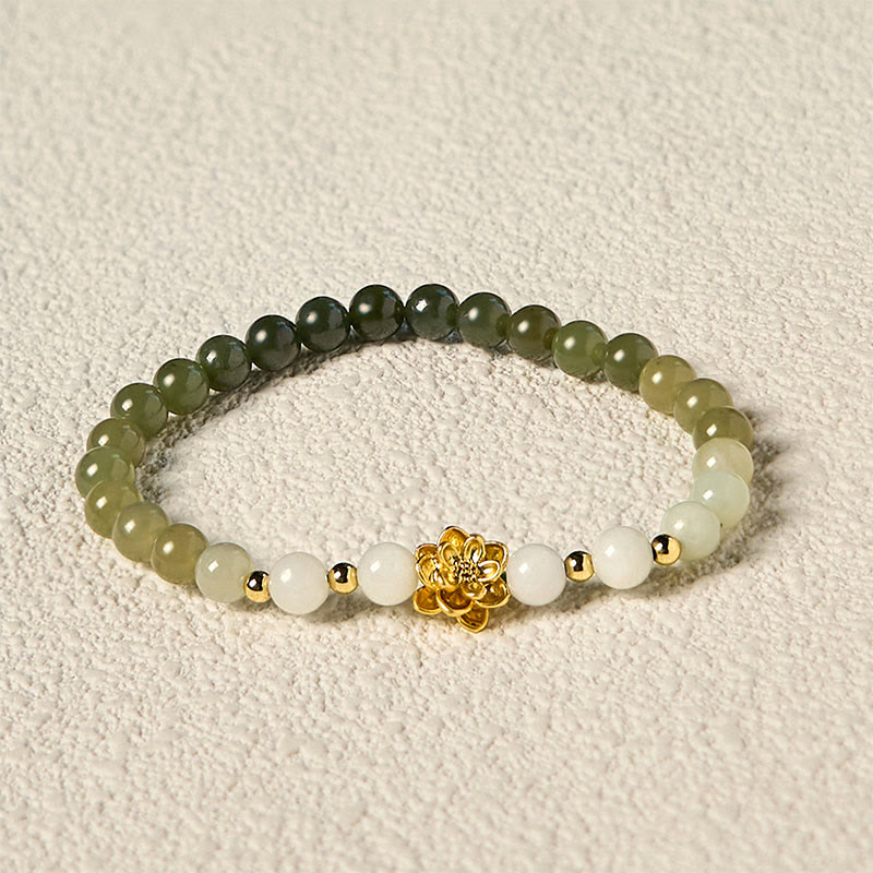 Hetian Jade Gradient Lotus Bracelet – jade ombre bracelet on cream fabric, gold lotus detail, Serene