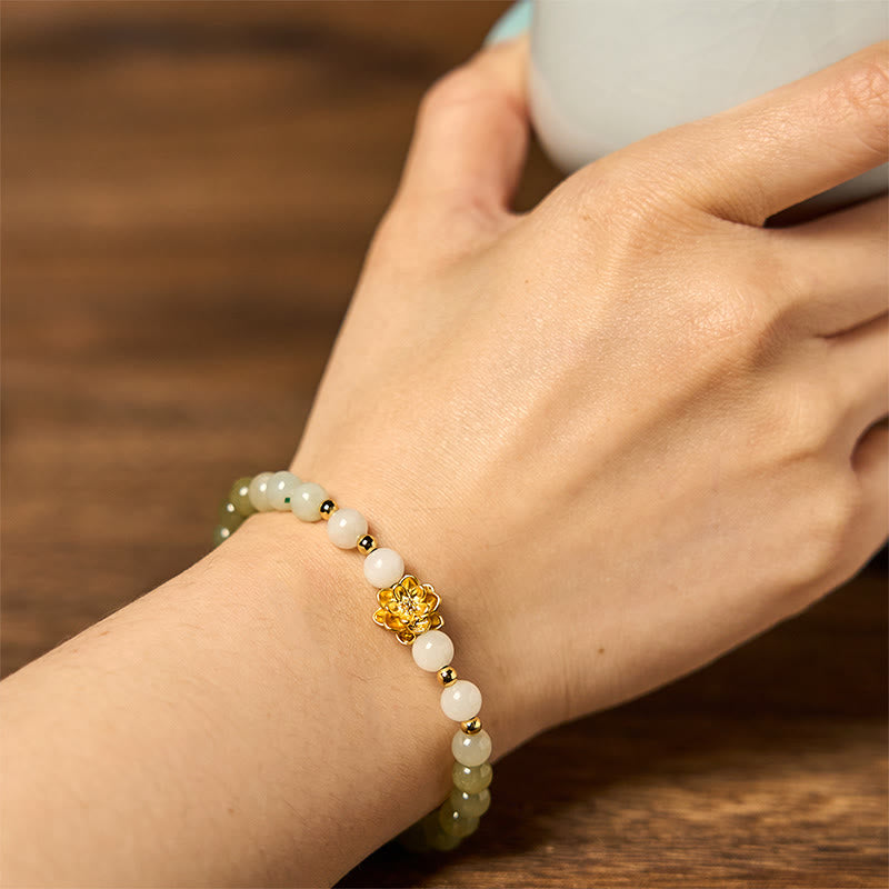 Natural Hetian Jade Gradient Lotus Bracelet – wrist shot with tea cup, jade lotus design, graceful