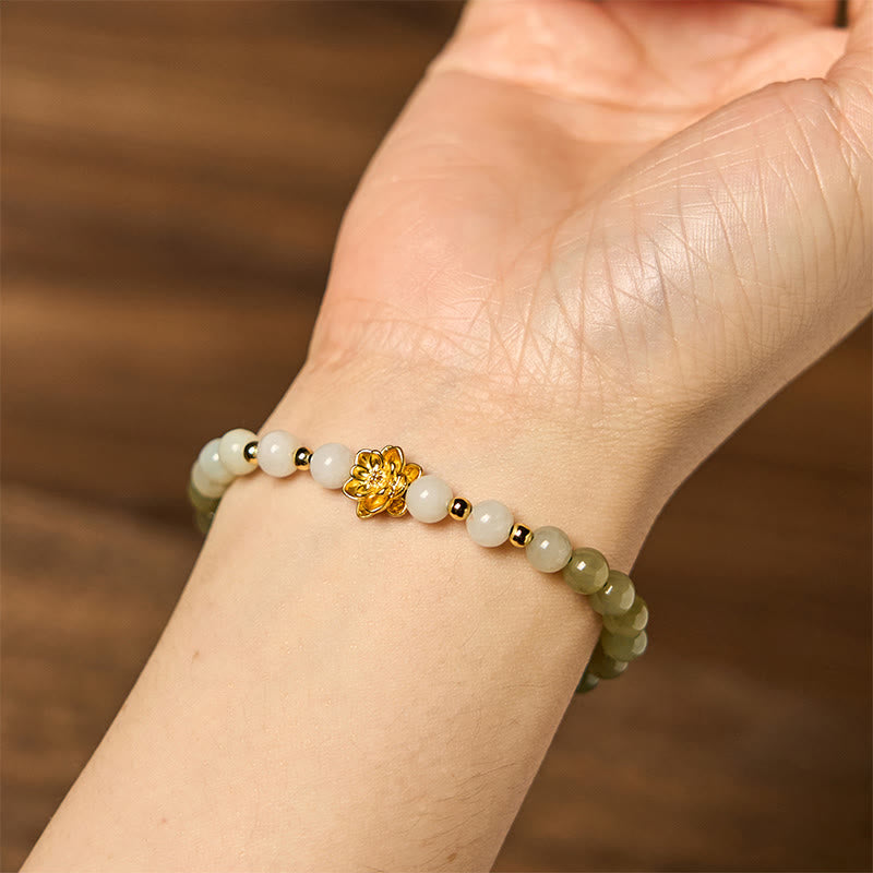 Hetian Jade Gradient Lotus Bracelet – worn on wrist over warm wood, natural jade gradient, Mindful