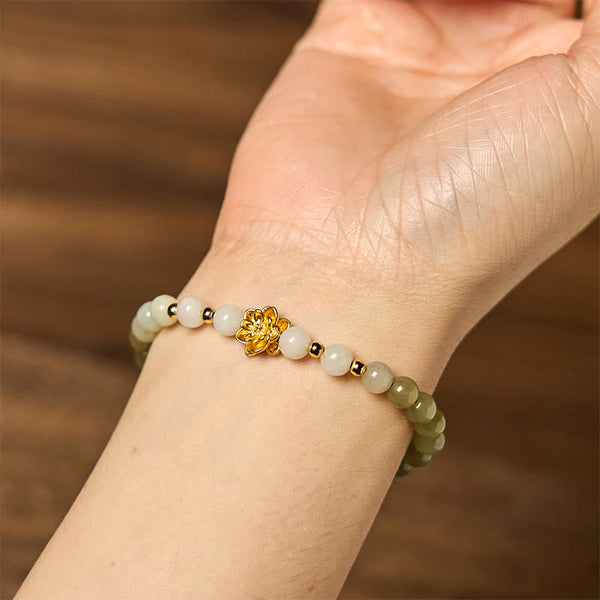 Hetian Jade Gradient Lotus Bracelet – worn on wrist over warm wood, natural jade gradient, Mindful