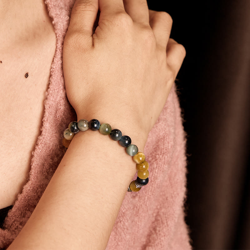 Red Tiger Eye Buddha Bracelet – on red fabric, monochromatic styling photography