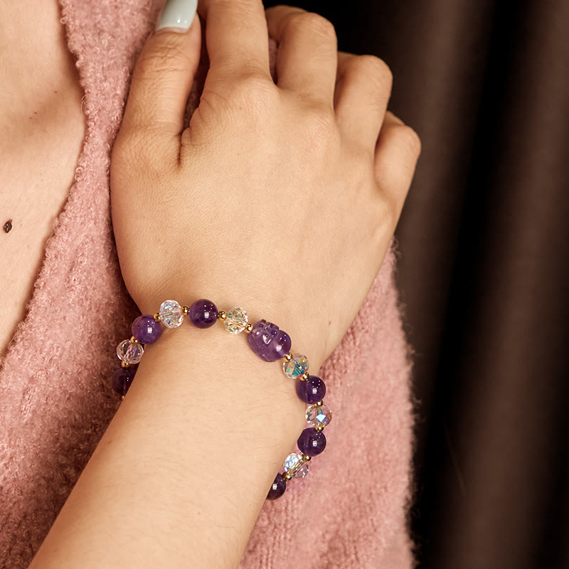 Amethyst PiXiu Bracelet – Worn on wrist with pink sweater, purple amethyst and crystal beads with PiXiu, spiritual jewelry