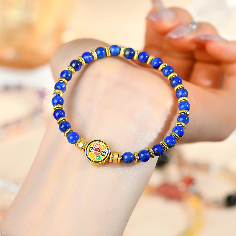 Lapis Lazuli Bracelet – on wrist with manicured nails and warm blurred jewelry display background, serenity balance