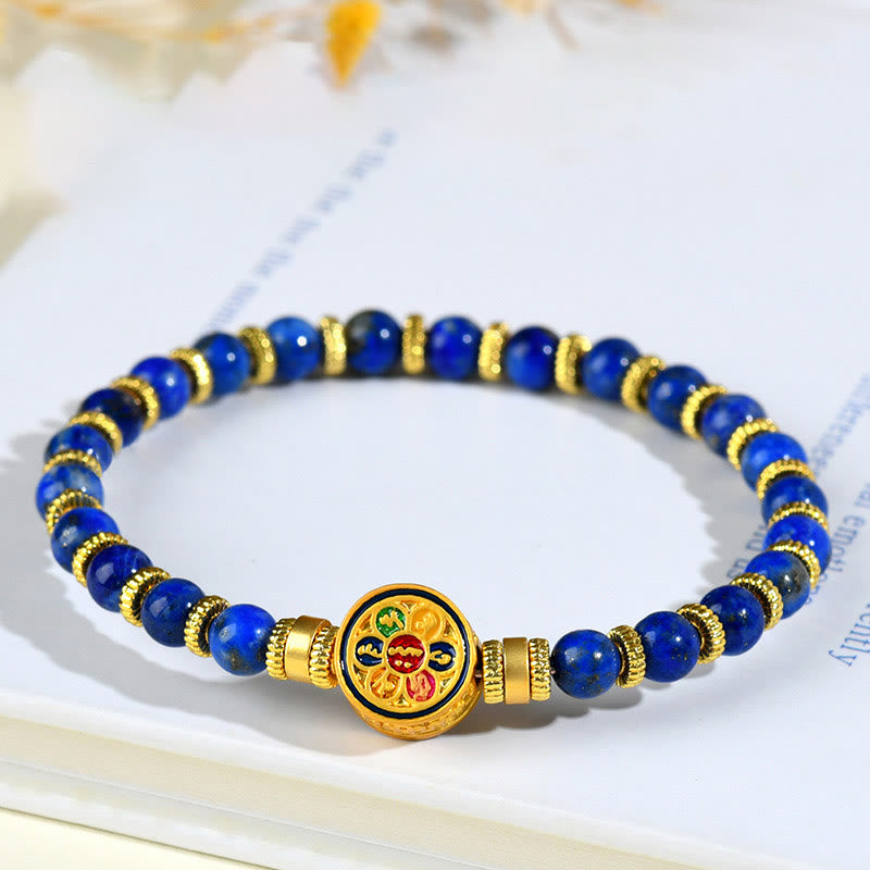 Lapis Lazuli Bracelet – blue beads with gold spacers and mantra medallion on open book with botanicals, balance Main image