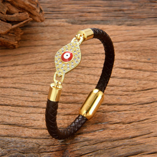 Dark chocolate leather evil eye bracelet with gold crystal pave charm, wood surface