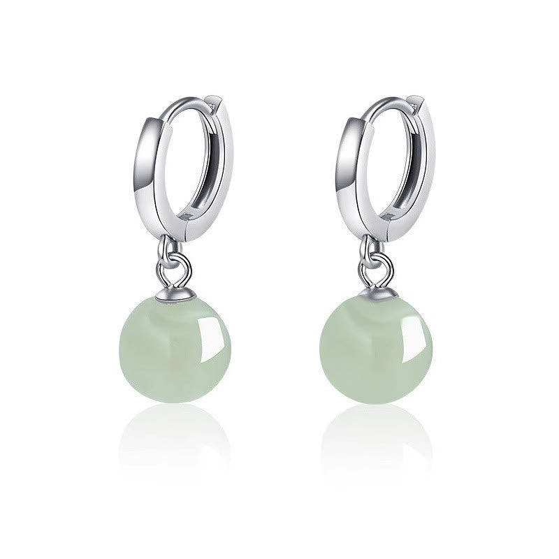 Round Jade Bead Prosperity Earrings – silver huggie hoops with translucent mint green jade beads, white seamless background, e-commerce front view