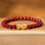 Natural Cinnabar Beads PiXiu Blessing Bracelet – gold PiXiu with glossy red cinnabar beads on beige fabric, protection bracelet