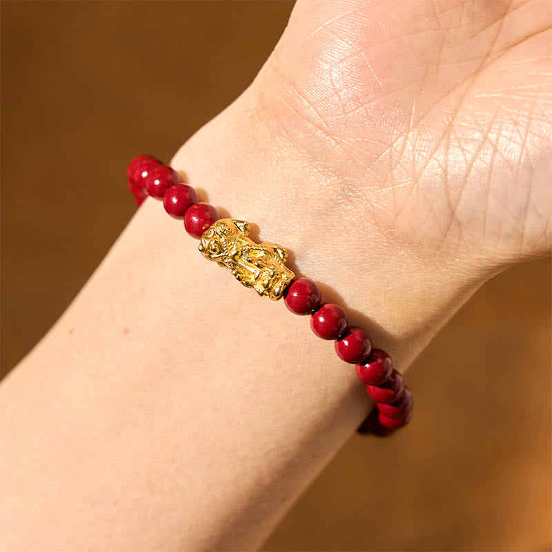 Natural Cinnabar Beads PiXiu Blessing Bracelet – closeup wrist shot with gold PiXiu and glossy red beads, calming jewelry