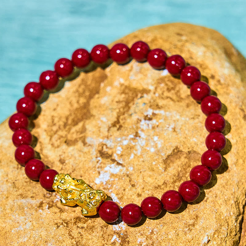 Natural Cinnabar Beads PiXiu Blessing Bracelet – gold PiXiu with red beads on natural stone by blue water, feng shui bracelet
