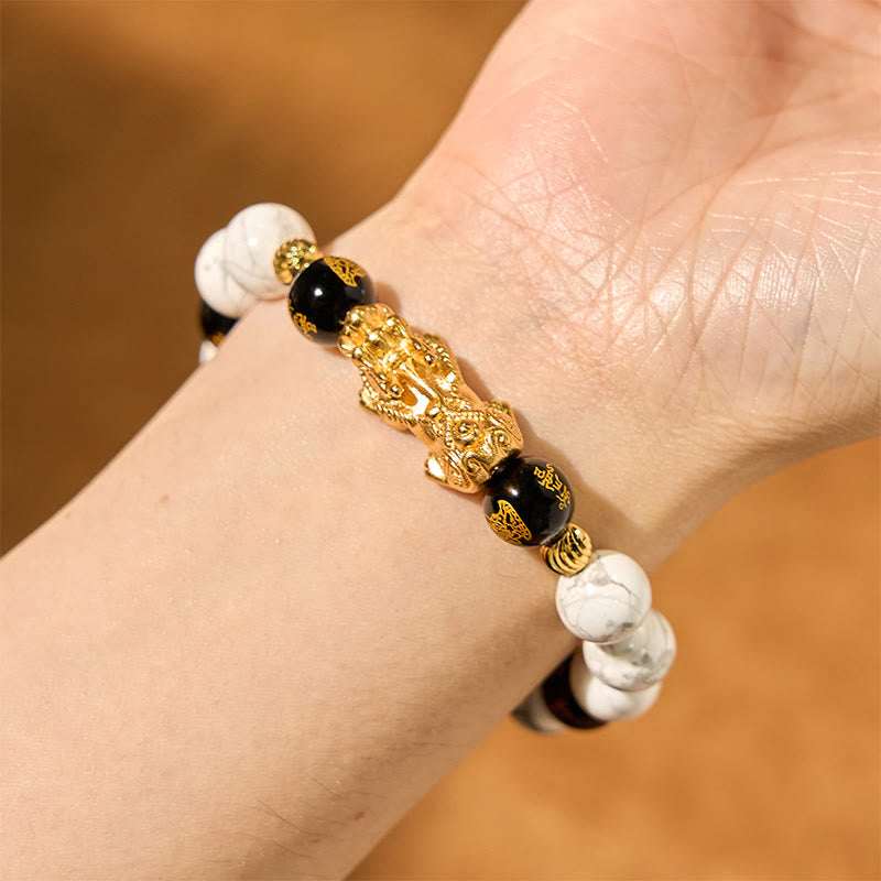 Vintage White Turquoise Black Onyx PiXiu Blessing Bracelet – wrist view with gold PiXiu on warm brown background, protection