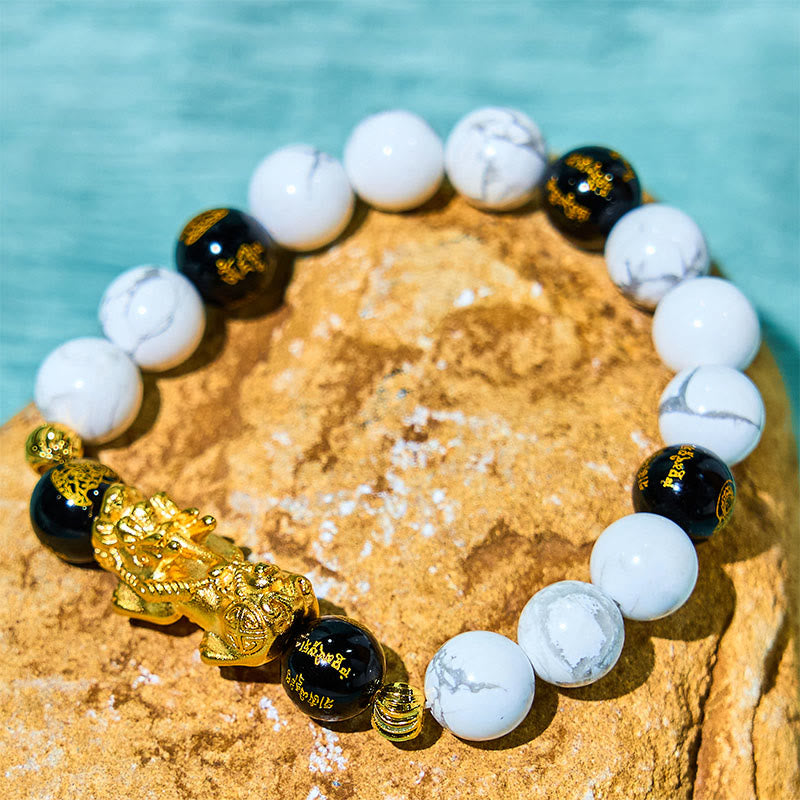Vintage White Turquoise Black Onyx PiXiu Blessing Bracelet – gold PiXiu with white and black beads on yellow rock waterside