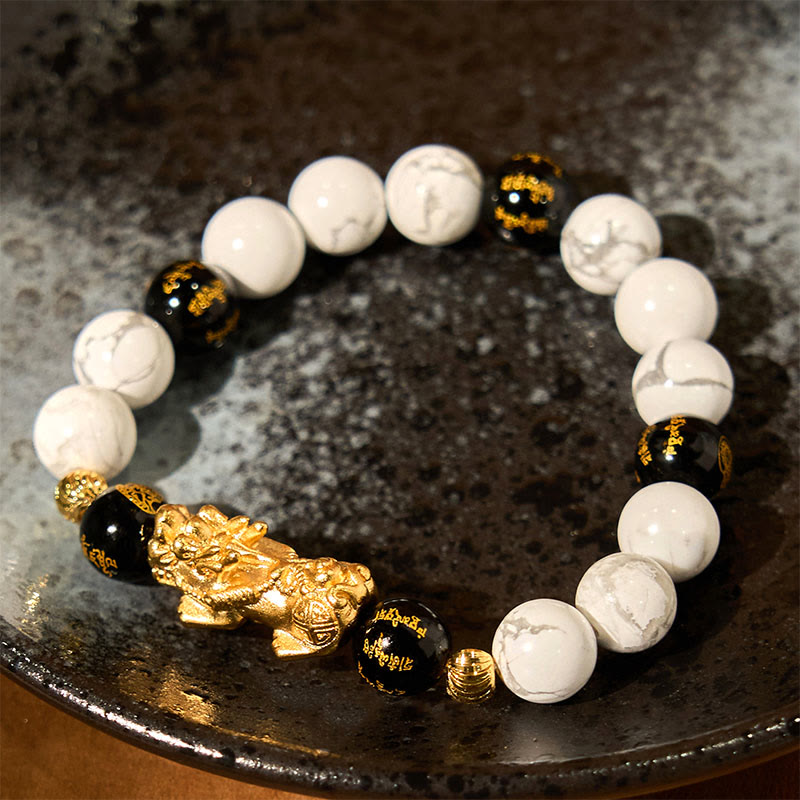 Vintage White Turquoise Black Onyx PiXiu Blessing Bracelet – gold PiXiu with white turquoise on dark speckled ceramic plate