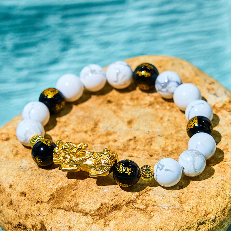 Vintage White Turquoise Black Onyx PiXiu Blessing Bracelet – gold PiXiu with white turquoise and black onyx on stone by water