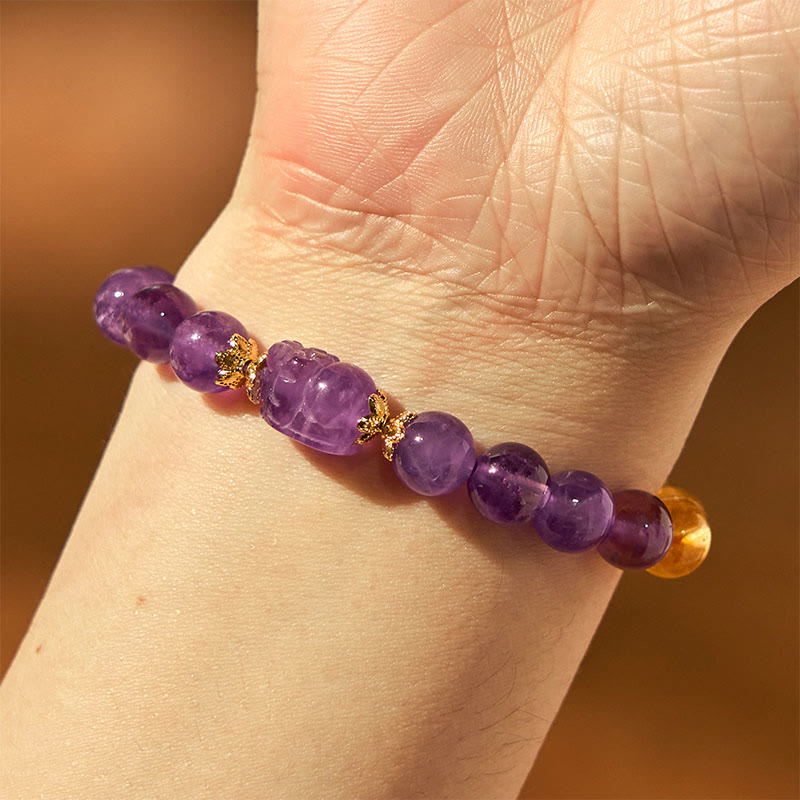 Citrine Amethyst PiXiu Prosperity Bracelet – wrist view with purple amethyst PiXiu on warm brown background, prosperity