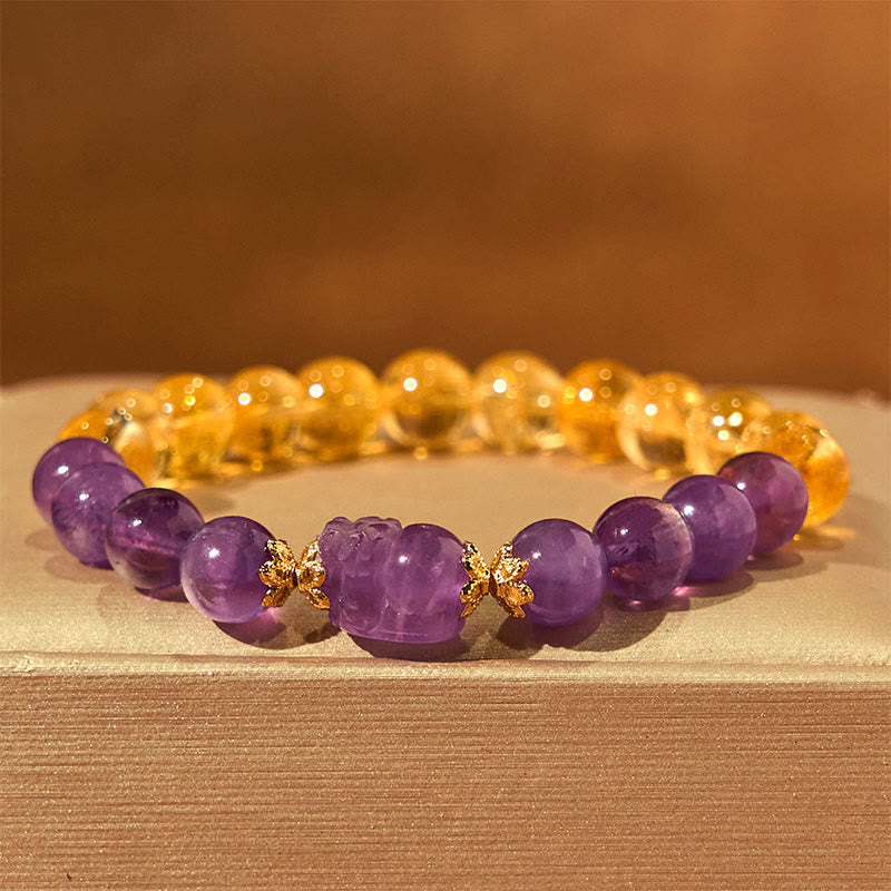 Citrine Amethyst PiXiu Prosperity Bracelet – amethyst PiXiu with citrine beads on cream fabric background, crystal jewelry