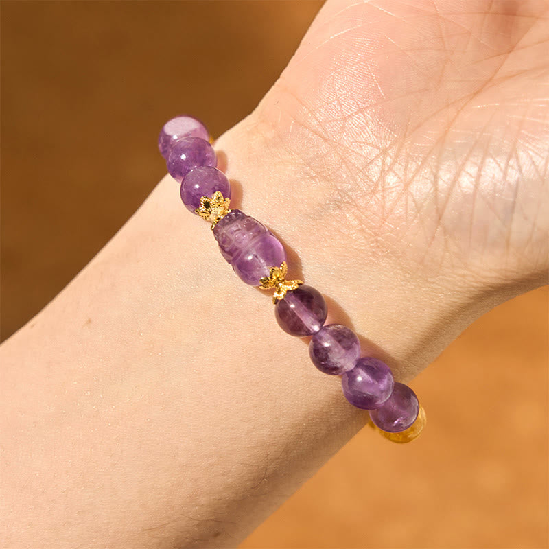Citrine Amethyst PiXiu Prosperity Bracelet – closeup wrist with purple PiXiu and citrine beads on skin tone, wealth peace