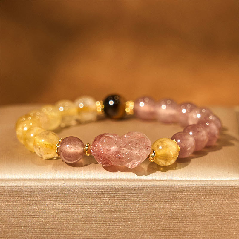 Strawberry Quartz PiXiu Rutilated Quartz Healing Bracelet – pink PiXiu with strawberry quartz and rutile on beige fabric