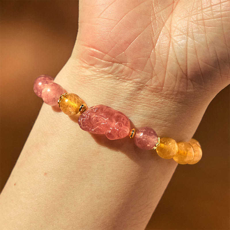 Strawberry Quartz PiXiu Rutilated Quartz Healing Bracelet – wrist view with pink strawberry quartz PiXiu on warm brown skin