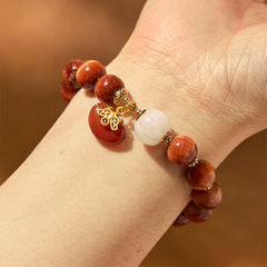 Natural Red Tiger Eye Pumpkin Calm Bracelet – Worn on wrist showing gold pendant and white bead detail, confidence jewelry