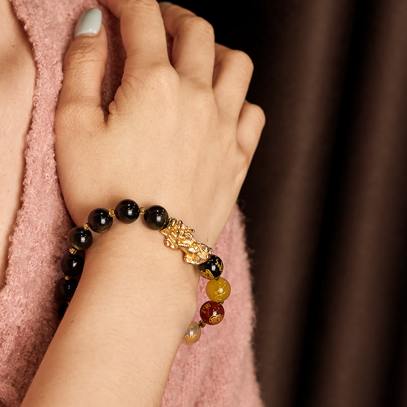 Gold Sheen Obsidian PiXiu Five Directions Gods of Wealth Bracelet – Worn on wrist with pink sweater, colorful wealth beads