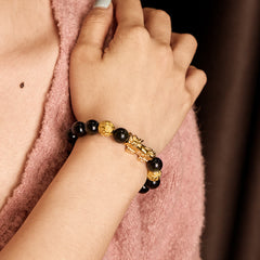 Gold Sheen Obsidian PiXiu Om Mani Padme Hum Wealth Bracelet – Worn on wrist with pink knit sweater, daily wealth bracelet