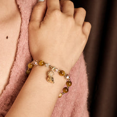 Yellow Tiger Eye Buddha Bracelet – chatoyant tiger eye gemstone beads shimmering close-up