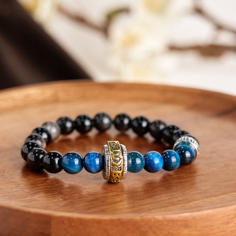 Om Mani Padme Hum Bracelet - Blue tiger eye and black obsidian beads on wooden tray, gemstone bracelet