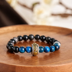 Om Mani Padme Hum Bracelet - Blue tiger eye and black obsidian beads on wooden tray, gemstone bracelet