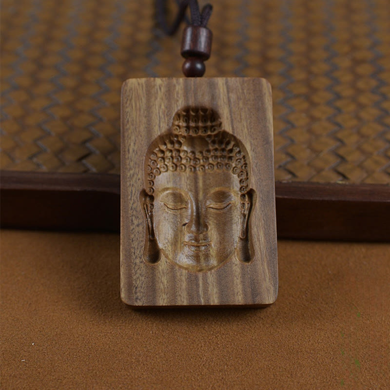 Green Sandalwood Buddha Necklace – Buddha symbol close-up with natural wood grain detail
