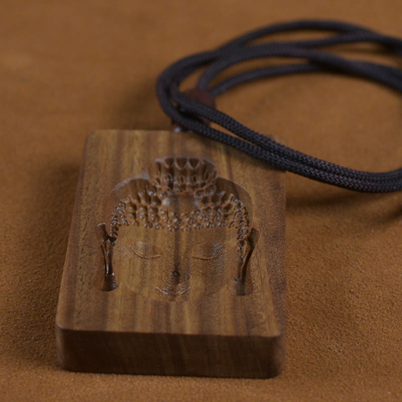 Green Sandalwood Buddha Necklace – size comparison next to coin, aromatic sandalwood