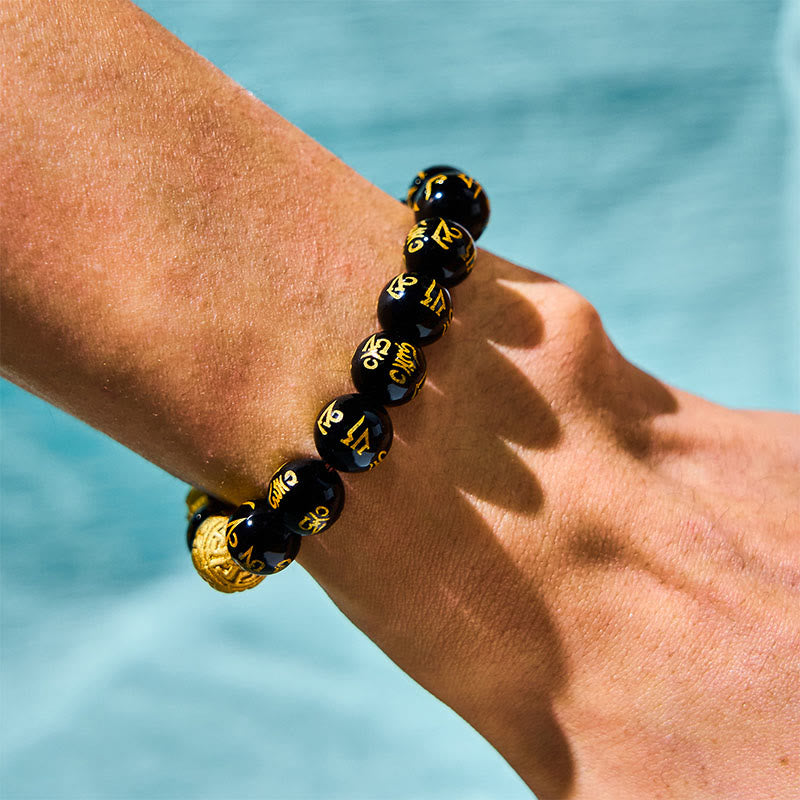FengShui PiXiu Obsidian Bracelet – black gold mantra bead detail wrist wealth jewelry close-up