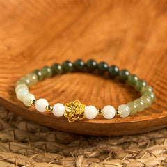 Hetian Jade Gradient Lotus Bracelet – ombre green-white beads on wooden dish with gold lotus, Balanced