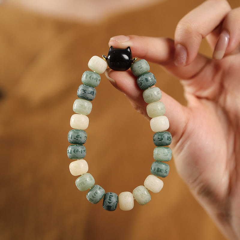 Bodhi Seed Silver Sheen Obsidian Cat Head Wisdom Bracelet – hand holding green variant, elegant gift