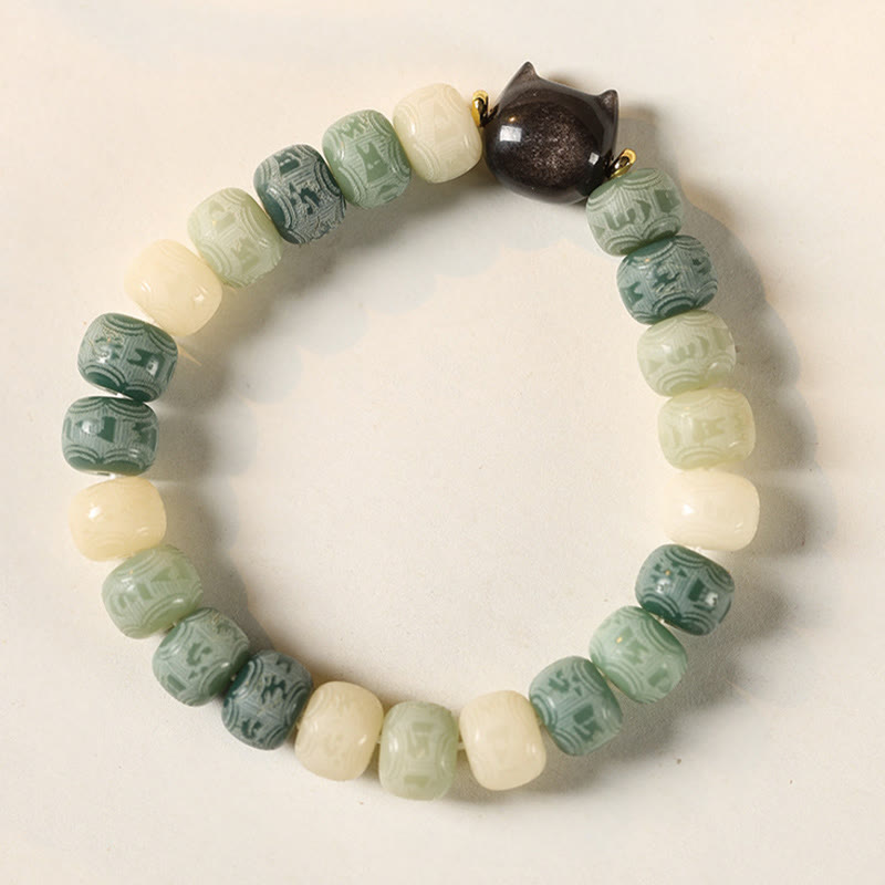 Bodhi Seed Silver Sheen Obsidian Cat Head Wisdom Bracelet – green variant flat lay white, peaceful energy