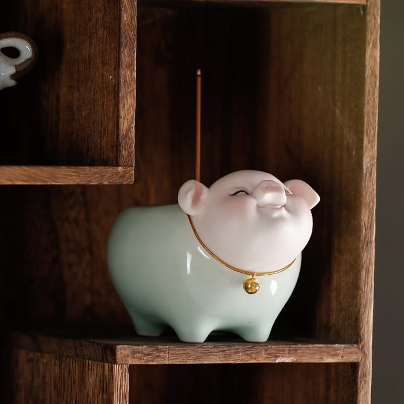 Ceramic Little Pig Incense Burner – Green and white pig in rustic wooden cubby, low angle