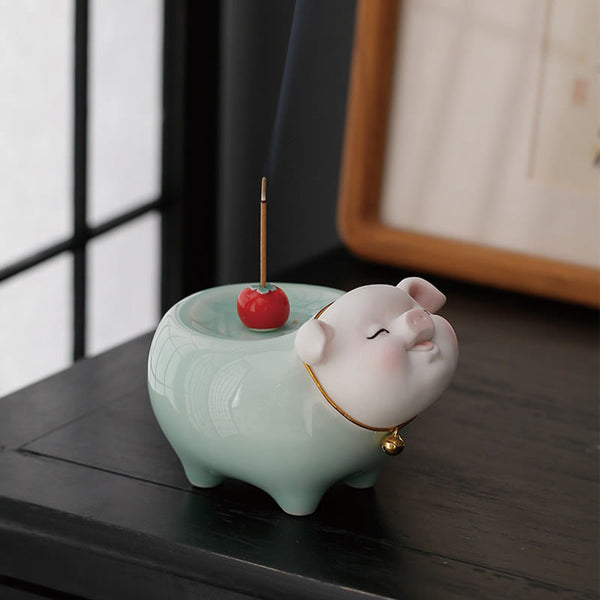 Ceramic Little Pig Incense Burner – Green pig with pink face, smoke rising from incense stick