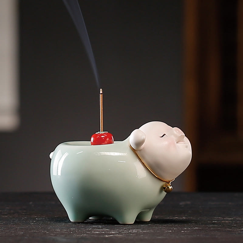 Ceramic Little Pig Incense Burner – Side view of celadon pig with burning incense, smoke rising